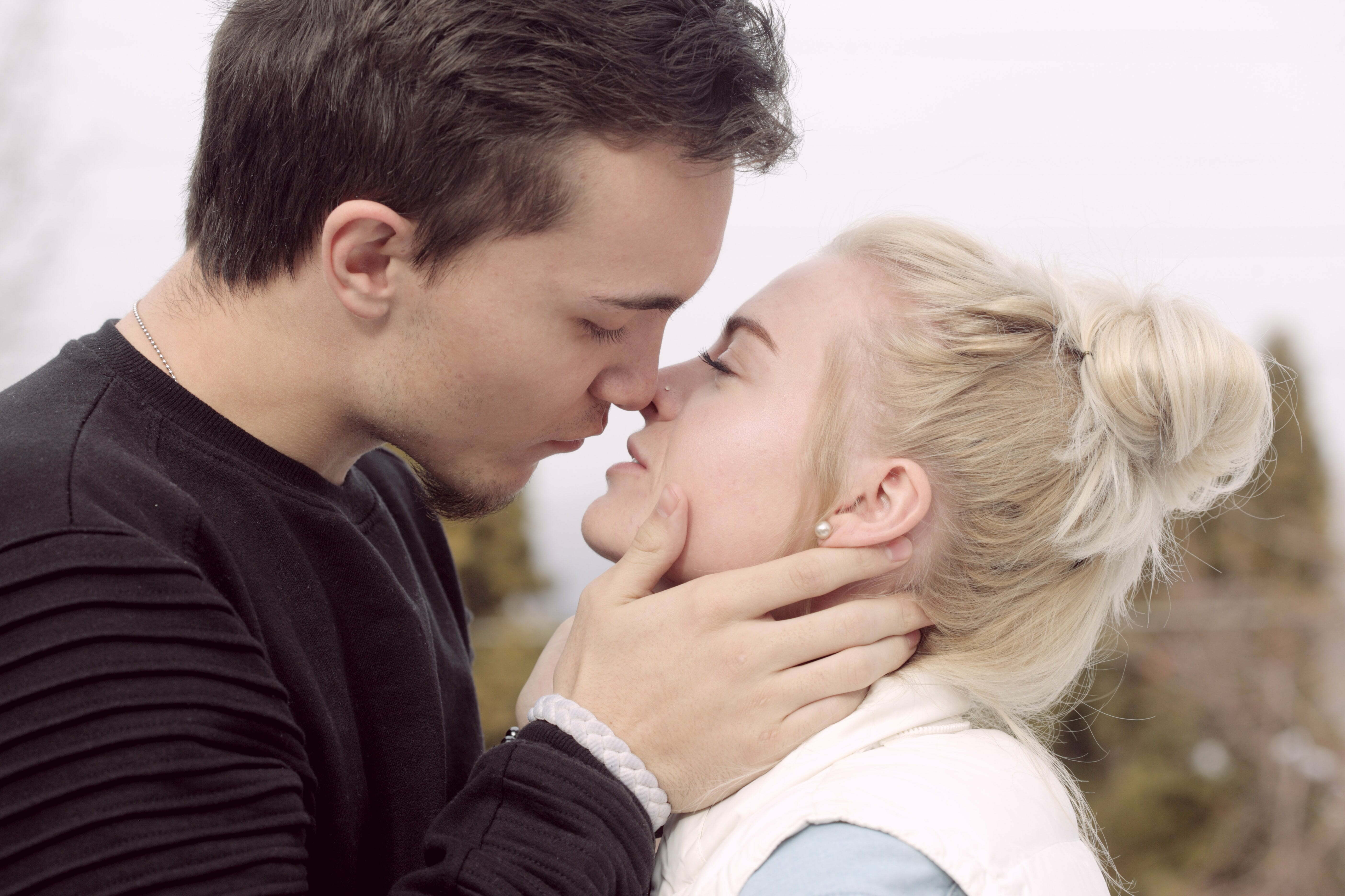 a man and woman kissing