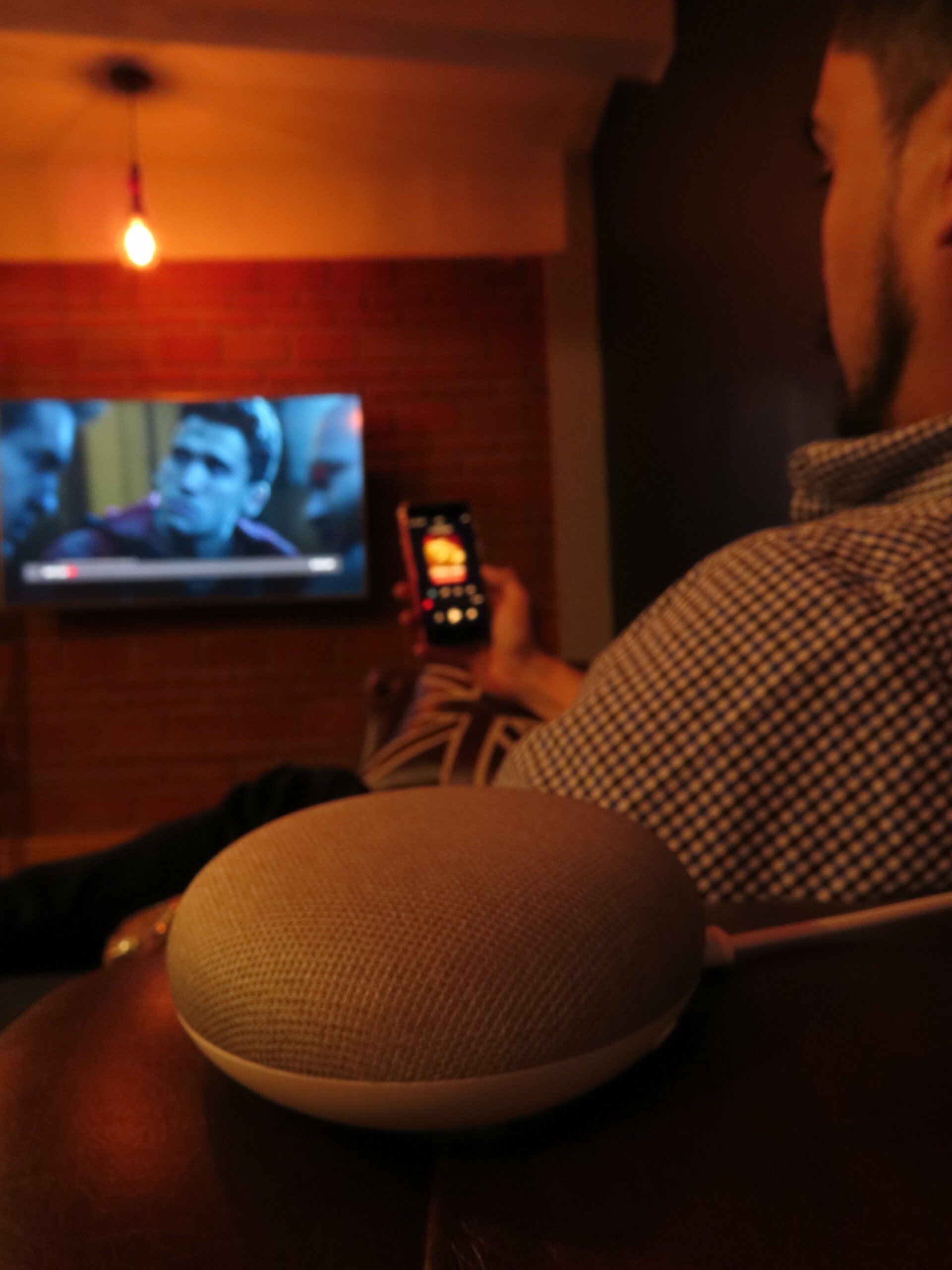 a person sitting at a table watching tv