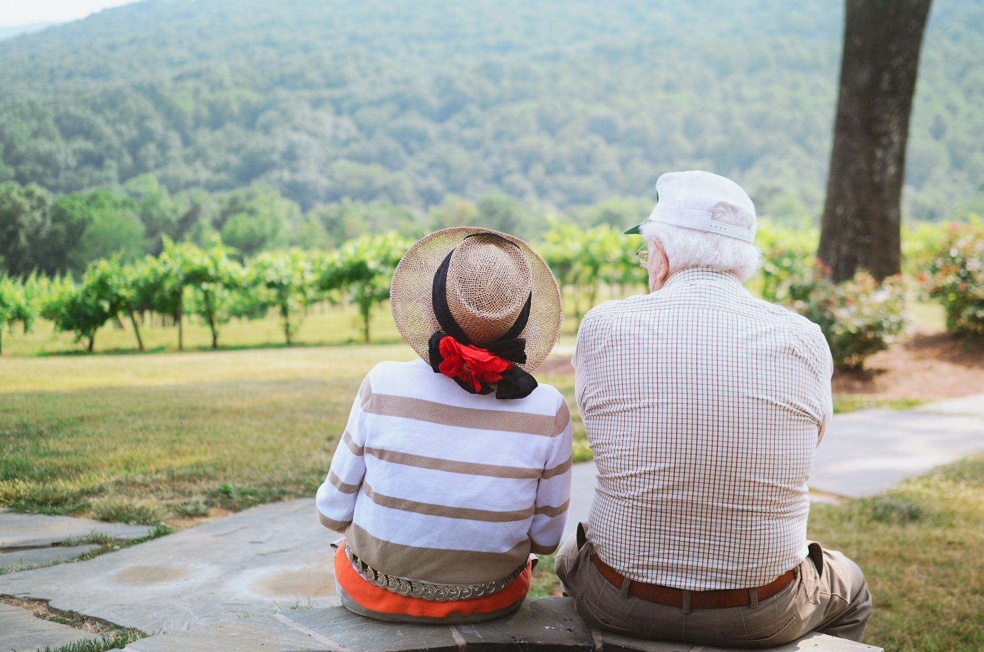 two people sitting on a stone ledge