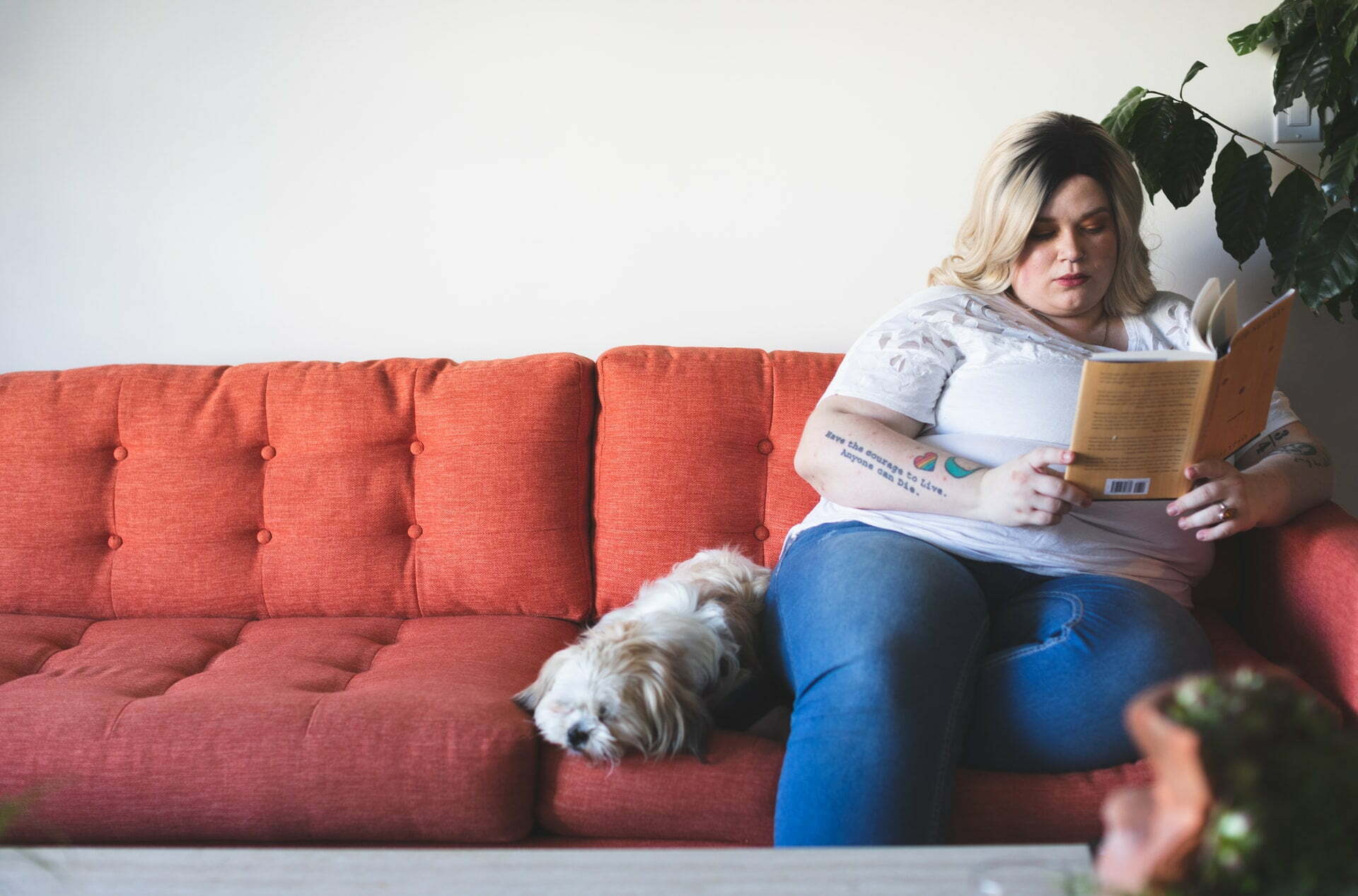 a person sitting on a couch reading a book