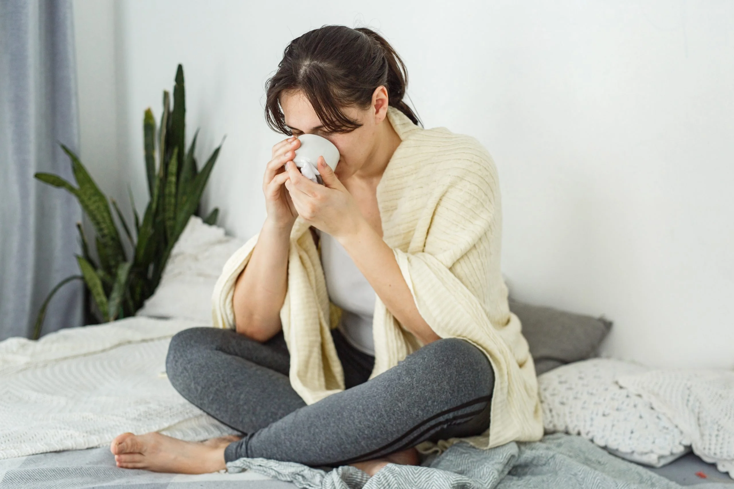 a woman sitting on a bed