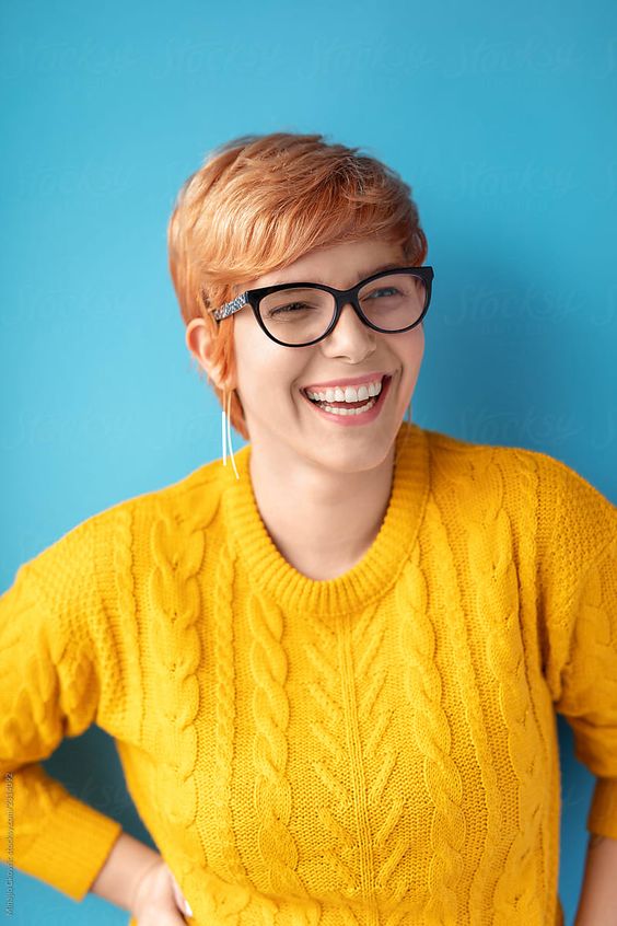 a smiling woman wearing glasses