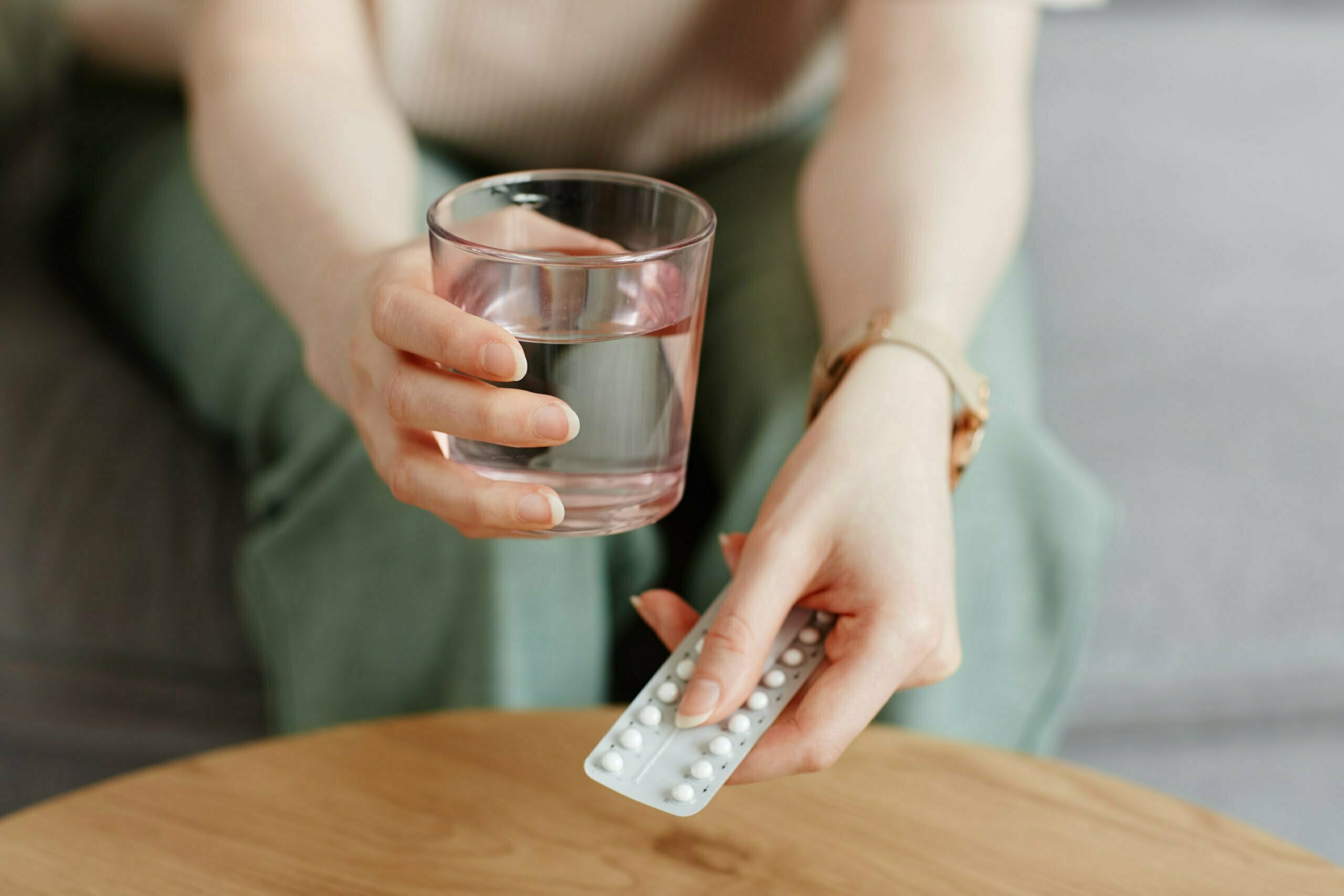 a person holding a glass of water