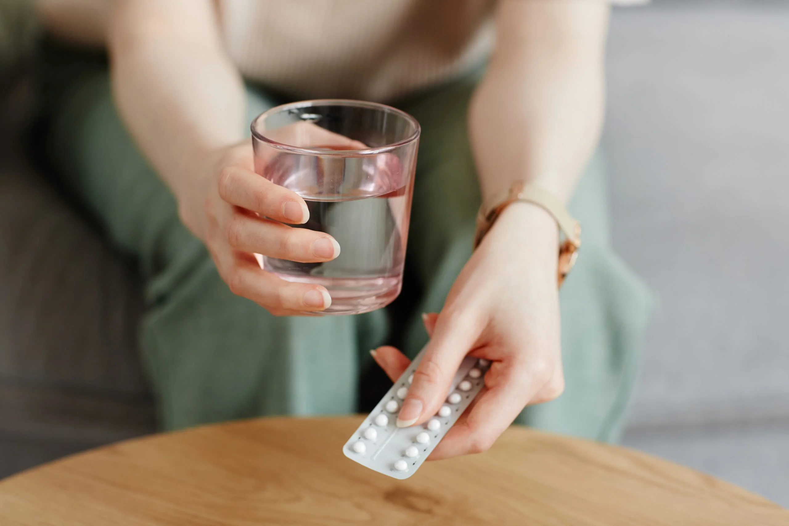 a person holding a glass of water
