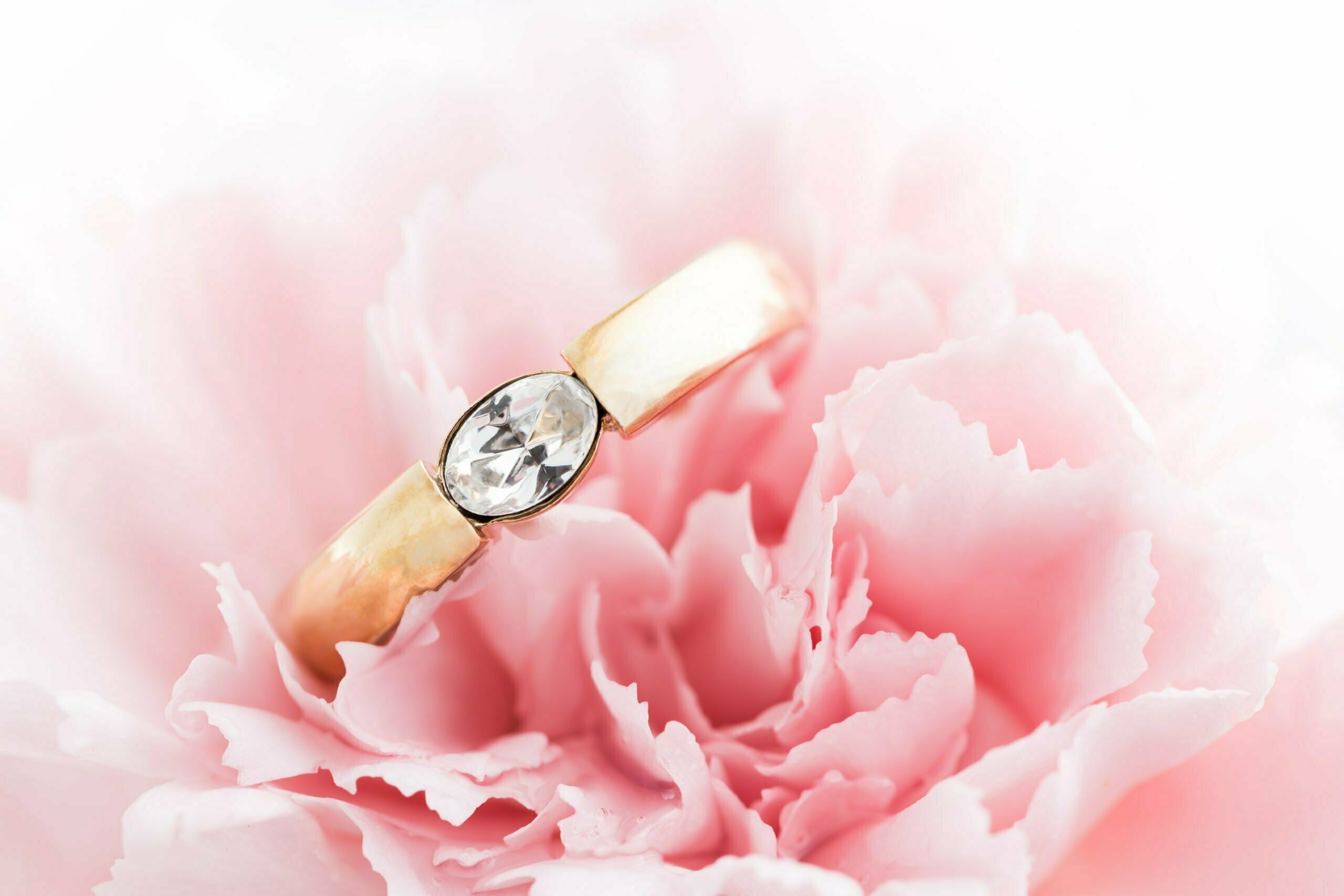 Wedding or engagement ring in a flower. Soft focus.